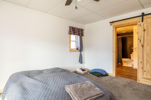 bedroom featuring a paneled ceiling, ceiling fan, and carpet