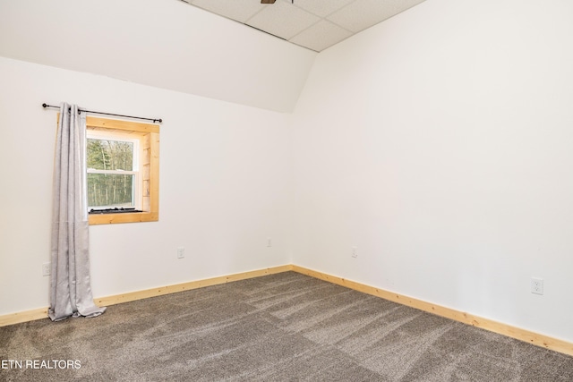 carpeted spare room featuring a paneled ceiling