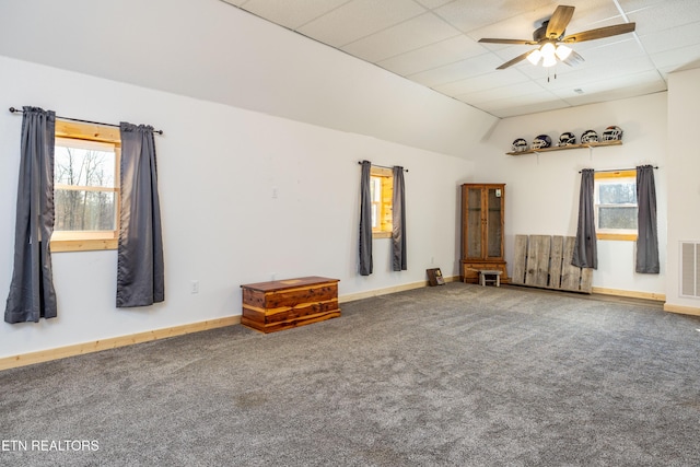 unfurnished living room with carpet flooring, ceiling fan, lofted ceiling, and a wealth of natural light