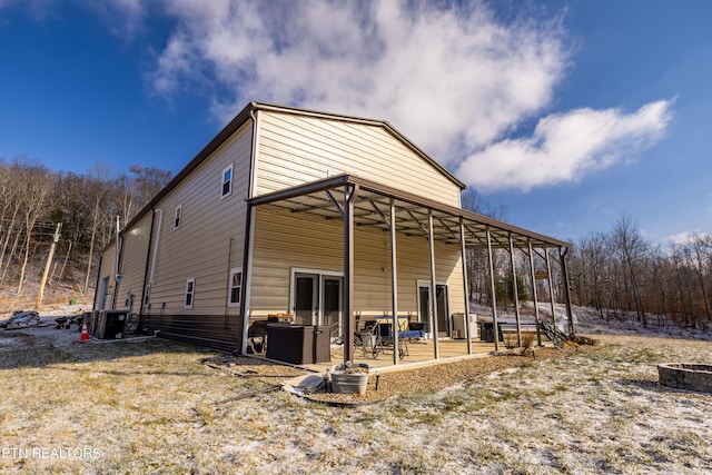 rear view of property featuring cooling unit and a patio area