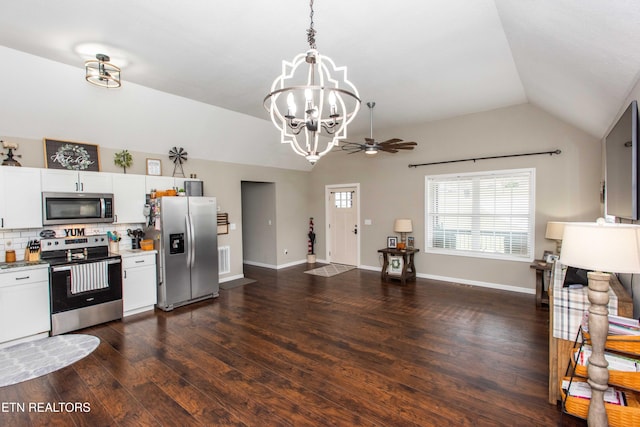 kitchen with appliances with stainless steel finishes, backsplash, ceiling fan with notable chandelier, vaulted ceiling, and white cabinetry