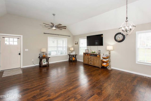 living room featuring plenty of natural light, dark hardwood / wood-style flooring, ceiling fan with notable chandelier, and lofted ceiling