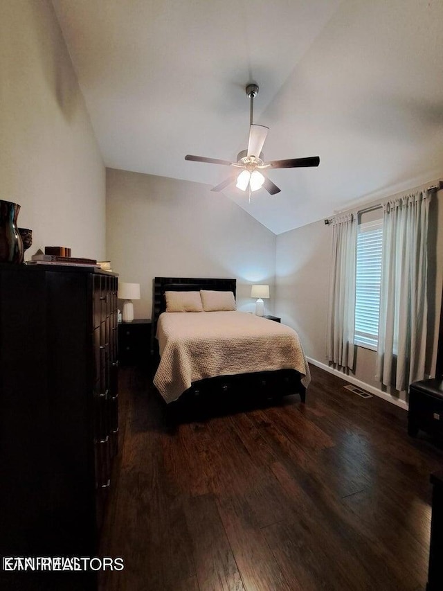 bedroom featuring lofted ceiling, ceiling fan, and dark wood-type flooring