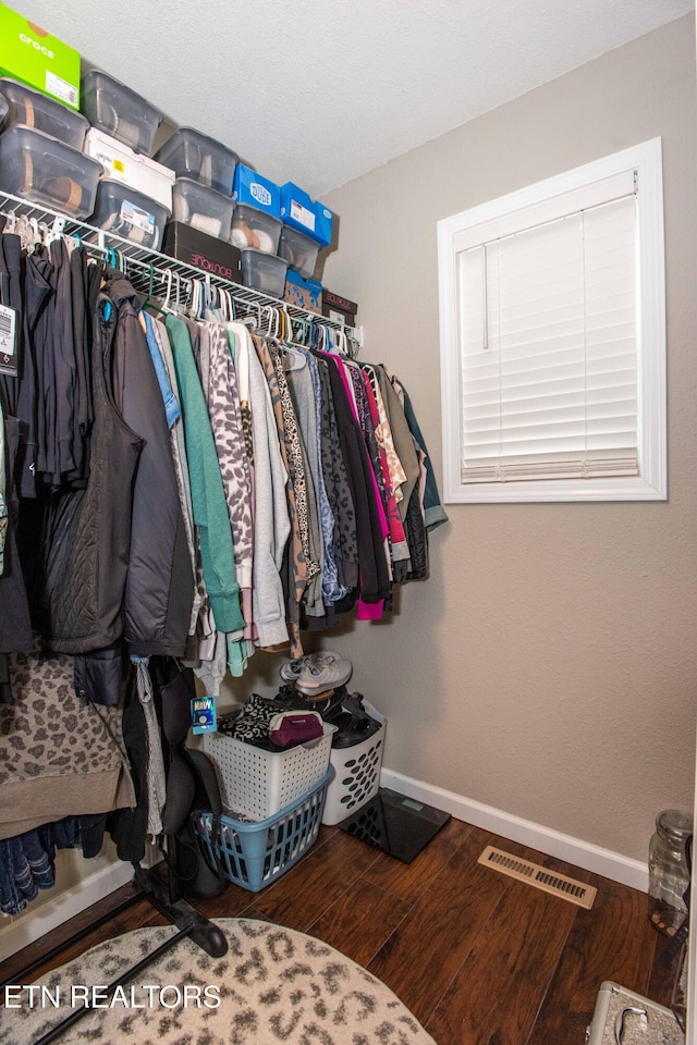 walk in closet with hardwood / wood-style floors