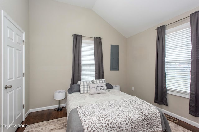 bedroom with hardwood / wood-style floors, lofted ceiling, and electric panel