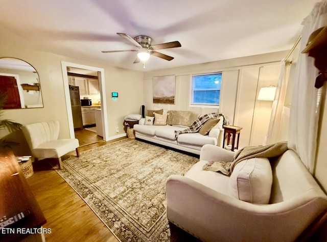 living room with hardwood / wood-style flooring and ceiling fan