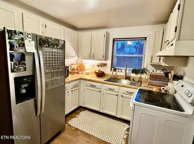 kitchen featuring stainless steel fridge with ice dispenser, sink, white cabinets, and white electric stove