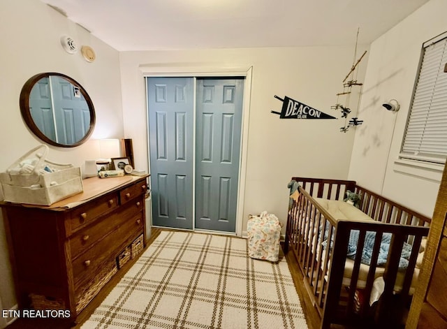 bedroom featuring a closet and a crib