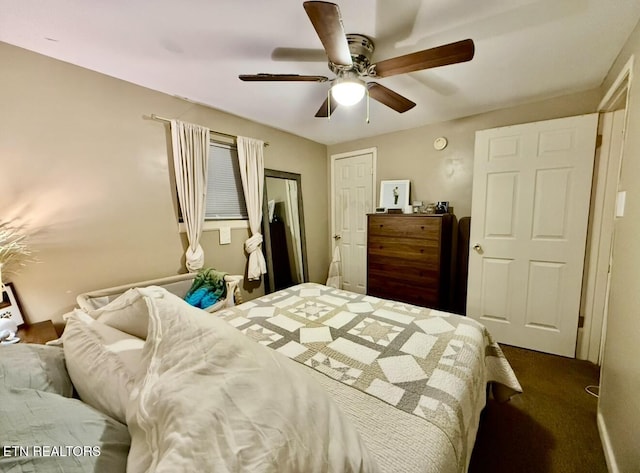 bedroom with dark colored carpet and ceiling fan