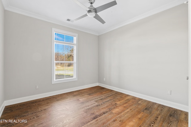 spare room with ceiling fan, dark wood-type flooring, and ornamental molding