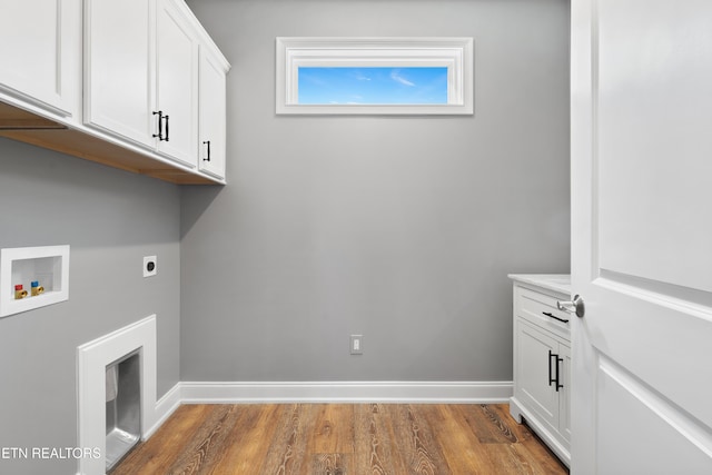 clothes washing area featuring hardwood / wood-style flooring, hookup for a washing machine, cabinets, and hookup for an electric dryer