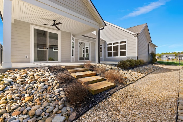 rear view of house featuring ceiling fan