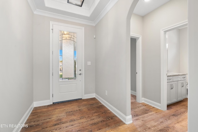 foyer with dark wood-type flooring and ornamental molding