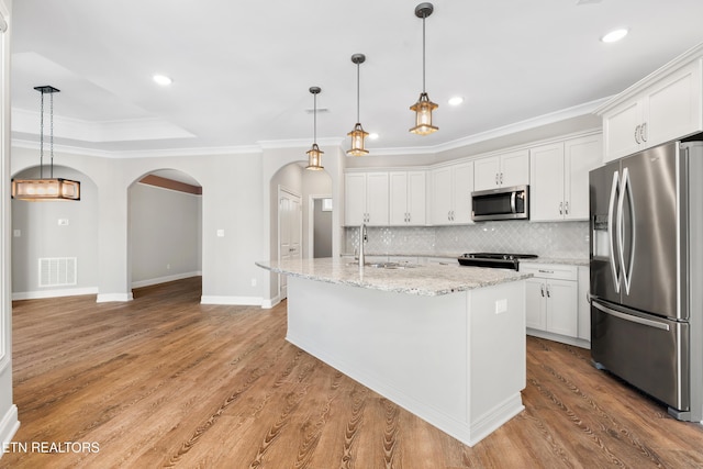 kitchen featuring a center island with sink, white cabinetry, and stainless steel appliances