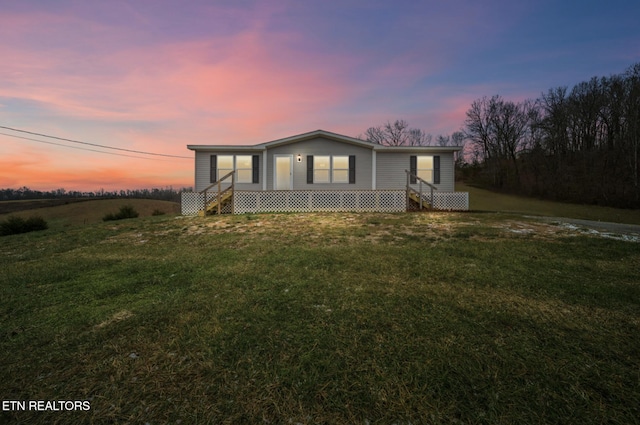 view of front of property with a yard