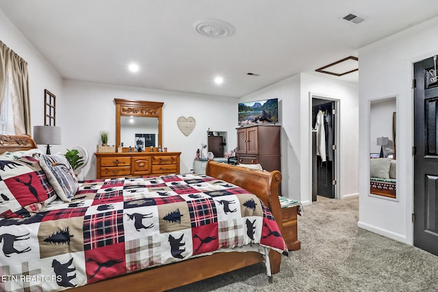 bedroom with carpet flooring and a spacious closet