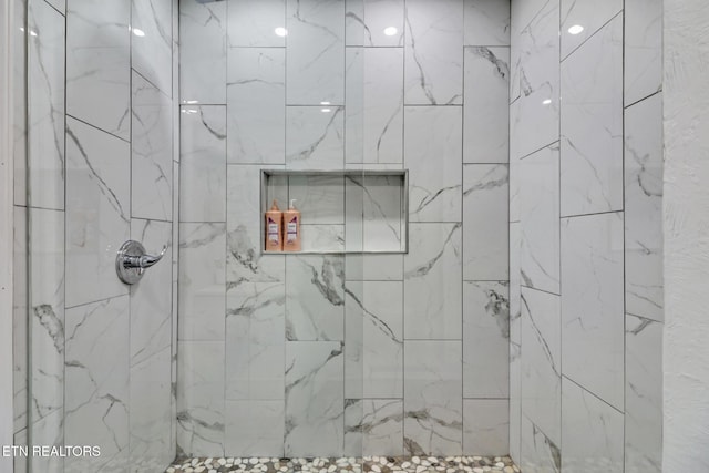 bathroom with tiled shower