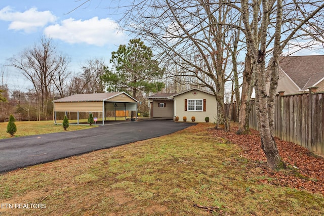 ranch-style home featuring a front yard and a carport