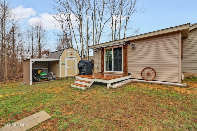 back of property featuring a yard, a shed, and a deck