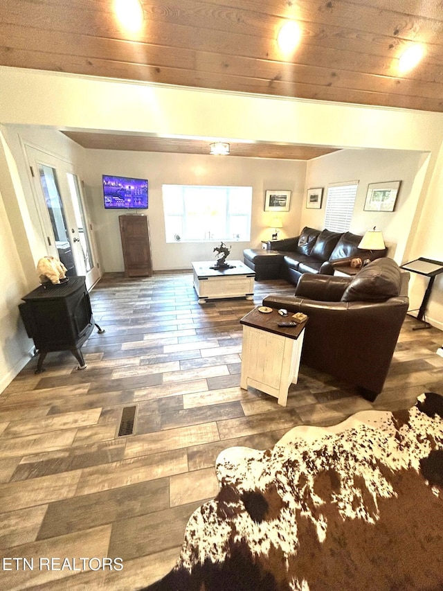 living room featuring dark hardwood / wood-style flooring and wooden ceiling