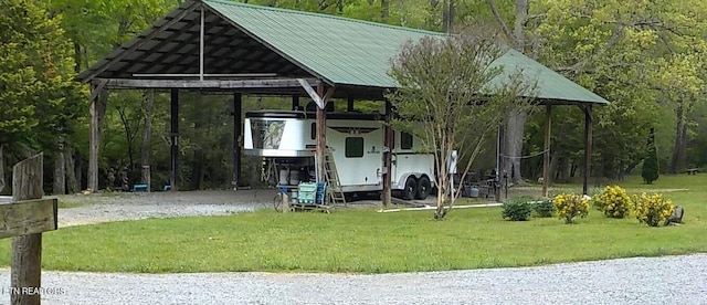 exterior space with a yard and a carport