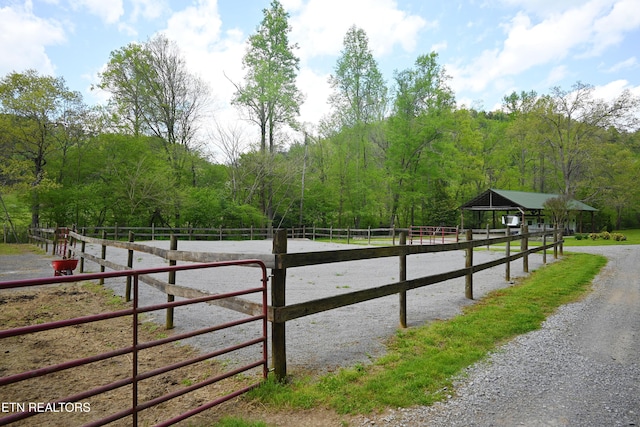 view of horse barn with a rural view