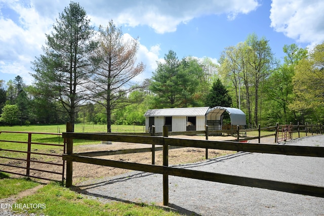 view of stable featuring a rural view