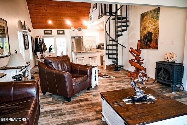 living room featuring wooden ceiling, a wood stove, wood-type flooring, and lofted ceiling