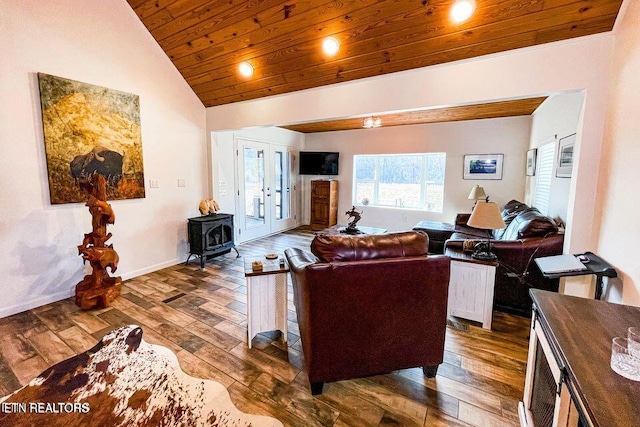 living room featuring french doors, a wood stove, lofted ceiling, wood ceiling, and dark wood-type flooring