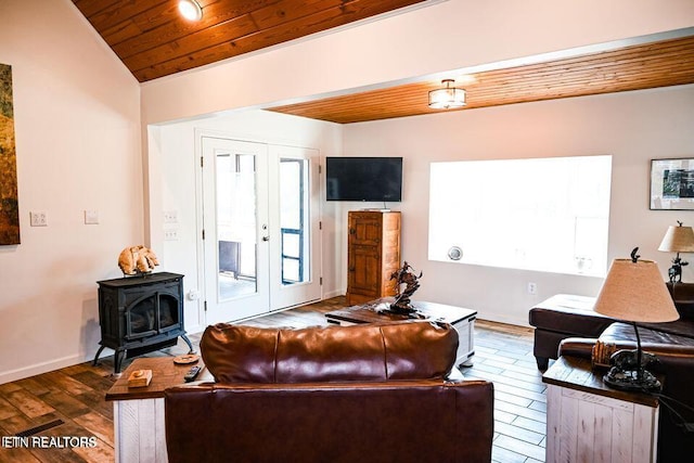 living room with french doors, a wood stove, wood ceiling, vaulted ceiling, and dark wood-type flooring