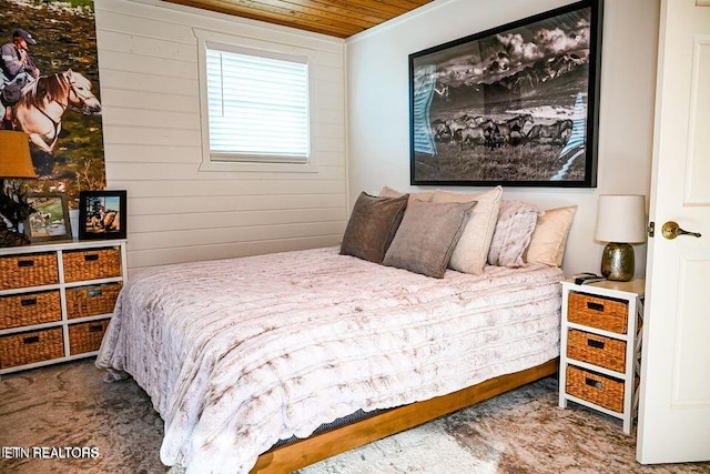 bedroom with dark carpet, wood walls, and wood ceiling