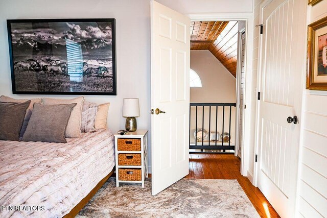 bedroom featuring hardwood / wood-style flooring, wooden ceiling, and lofted ceiling