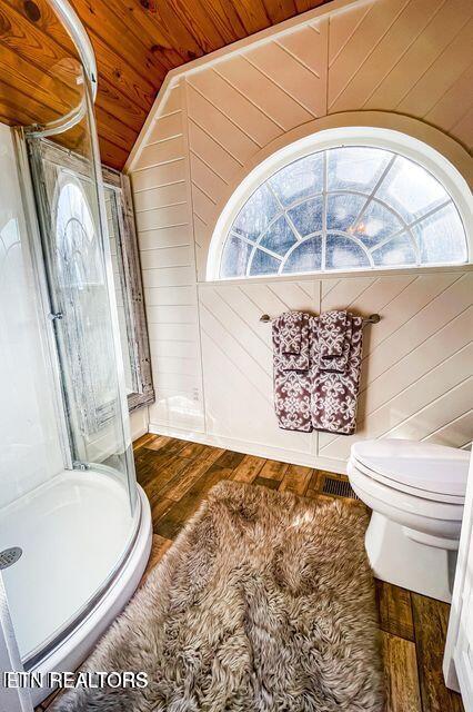 bathroom with toilet, vaulted ceiling, wooden ceiling, wood-type flooring, and wooden walls