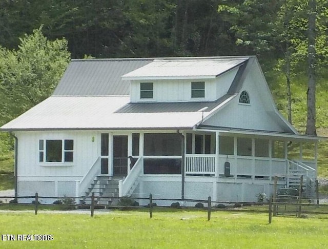 view of front of property with covered porch and a front lawn