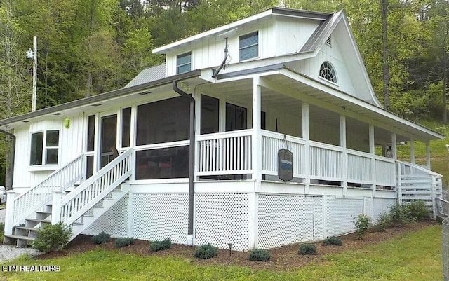 view of home's exterior featuring a yard and a sunroom