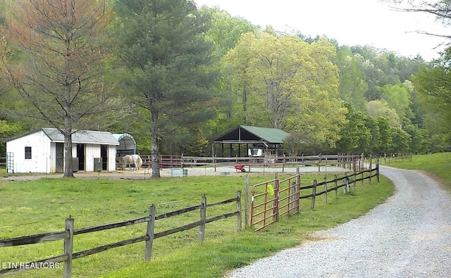 exterior space with a rural view and an outdoor structure