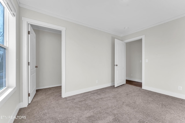 unfurnished bedroom with carpet and crown molding