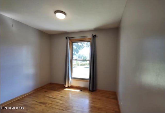 spare room featuring light hardwood / wood-style floors