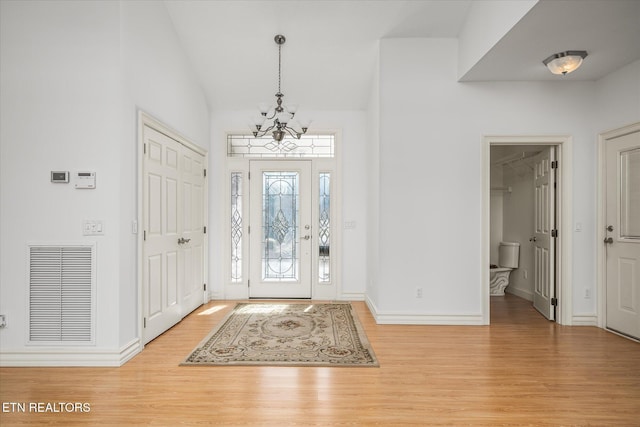 foyer featuring light hardwood / wood-style floors and a notable chandelier