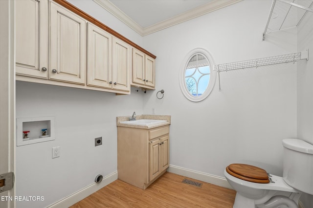 laundry area featuring sink, electric dryer hookup, hookup for a washing machine, light hardwood / wood-style floors, and ornamental molding