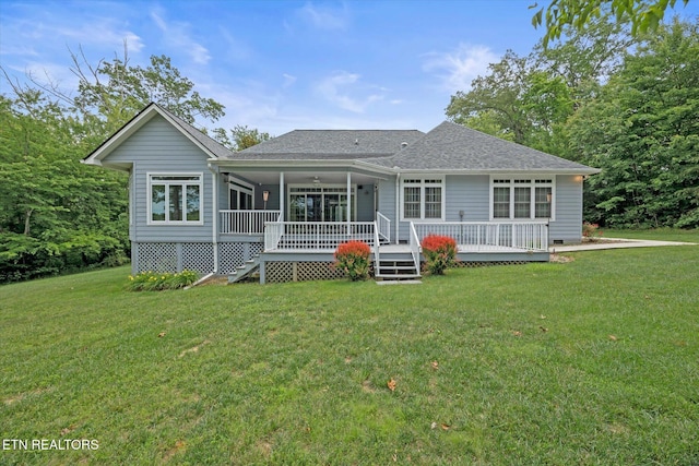 rear view of property with a yard and a deck