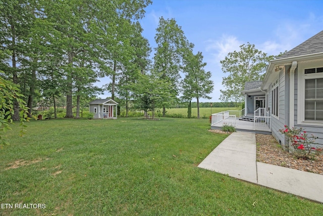 view of yard with an outbuilding and a deck