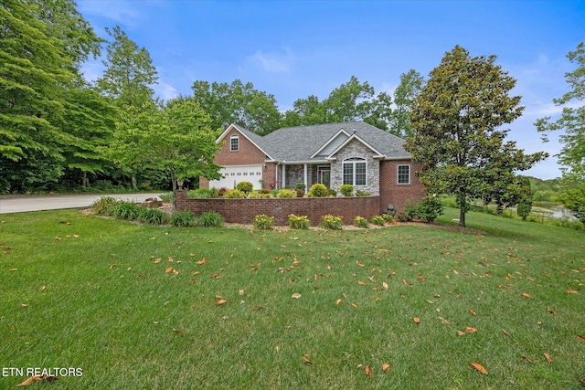 view of front of house featuring a front lawn and a garage