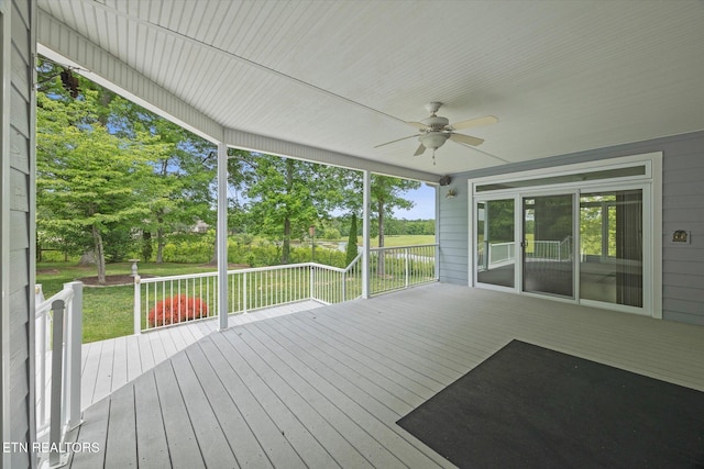 unfurnished sunroom with ceiling fan