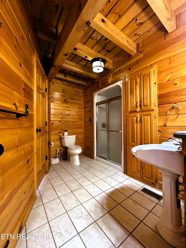 bathroom featuring wooden ceiling, beamed ceiling, tile patterned floors, wooden walls, and a shower with door