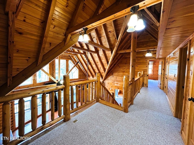 hall featuring rustic walls, light carpet, lofted ceiling with beams, wooden walls, and wood ceiling