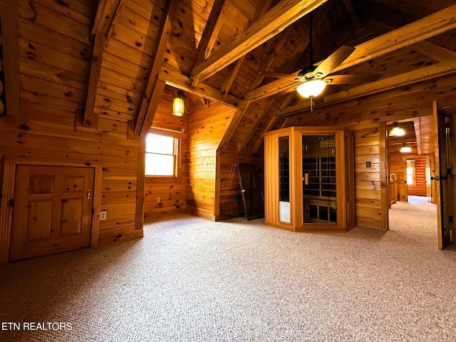 additional living space featuring ceiling fan, wooden ceiling, vaulted ceiling with beams, wooden walls, and carpet