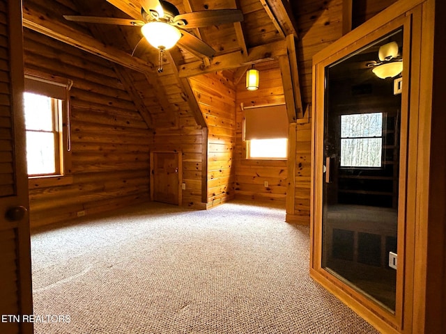 additional living space with a healthy amount of sunlight, wood ceiling, and log walls