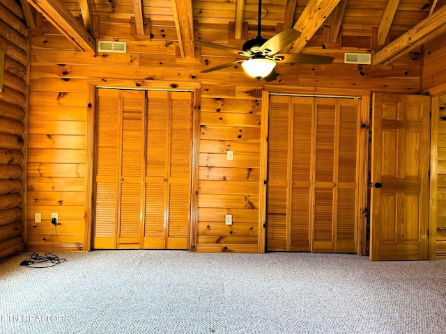 interior space featuring ceiling fan, beamed ceiling, and wooden ceiling