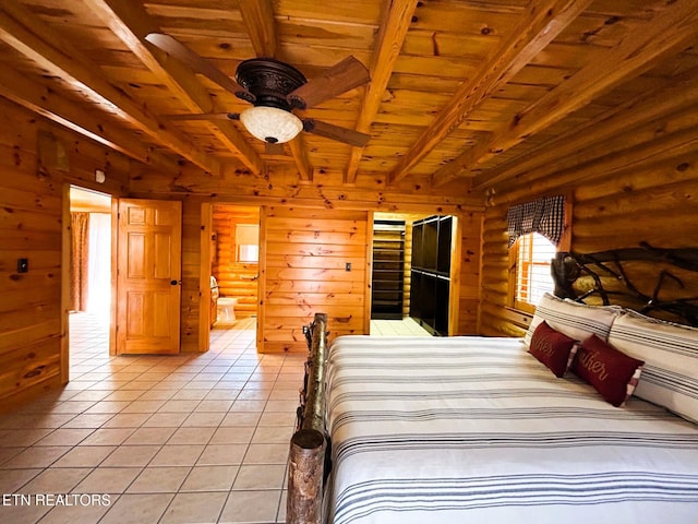 unfurnished bedroom with ensuite bathroom, wood ceiling, log walls, beam ceiling, and light tile patterned flooring